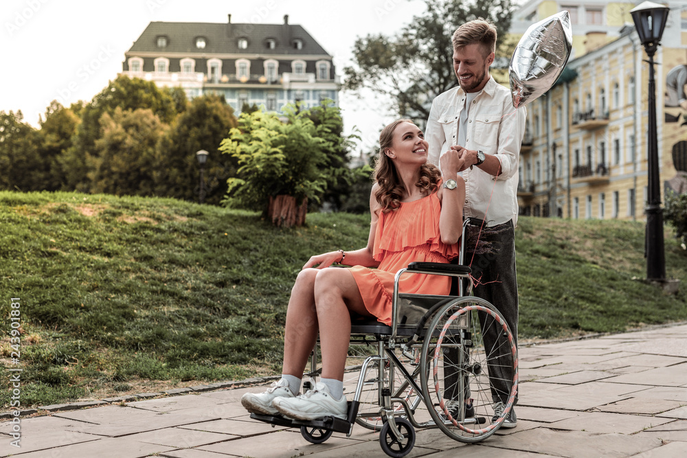 Charming invalid female person walking on wheelchair