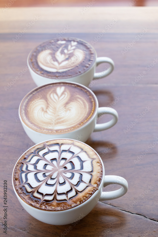 Coffee cup with latte art foam on wood table in coffee shop with copy space.Coffee is one of the most popular beverages.Improve Energy Levels and Burn Fat Coffee cup with latte art foam on wood table in coffee shop with copy space.Coffee is one of the most popular beverages.Improve Energy Levels and Burn Fat