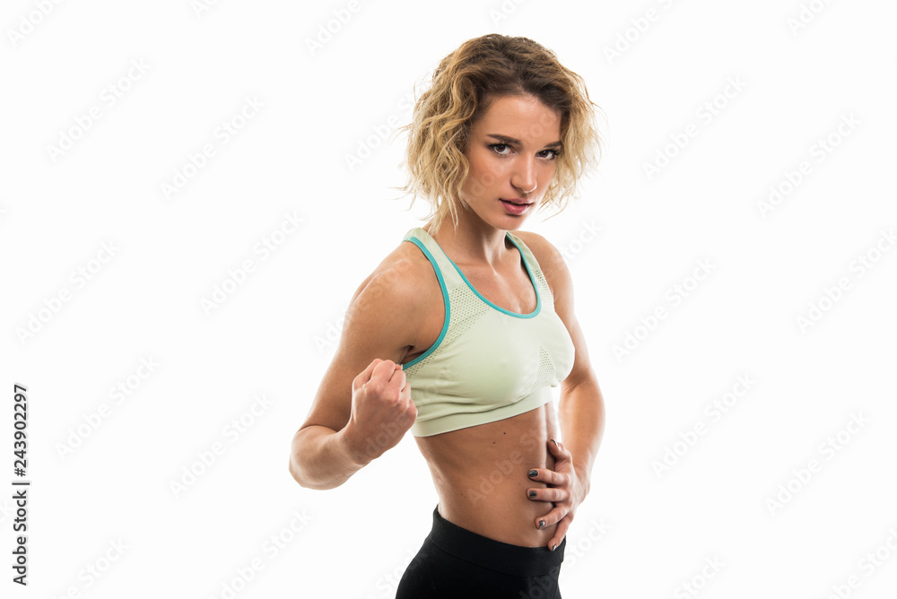 Portrait of fit girl holding abs making strong gesture Portrait of fit girl holding abs making strong gesture