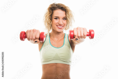 Beautiful young fit girl working out with dumbbells