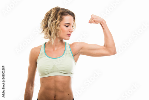Portrait of fit girl showing her biceps