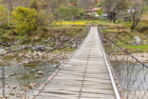 wooden suspension bridge over a river in the mountains  China Shaanxi Province