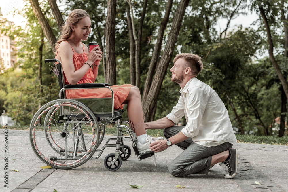 Positive delighted bearded man helping his girlfriend Positive delighted bearded man helping his girlfriend