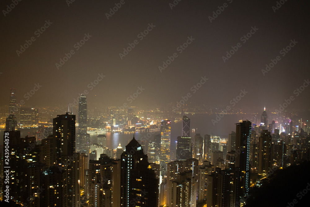 Architecture city skyline with lights at night time evening shot from the peak tourist destination in Hong Kong