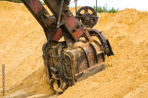  huge excavator bucket digs sand in  sand quarry mining