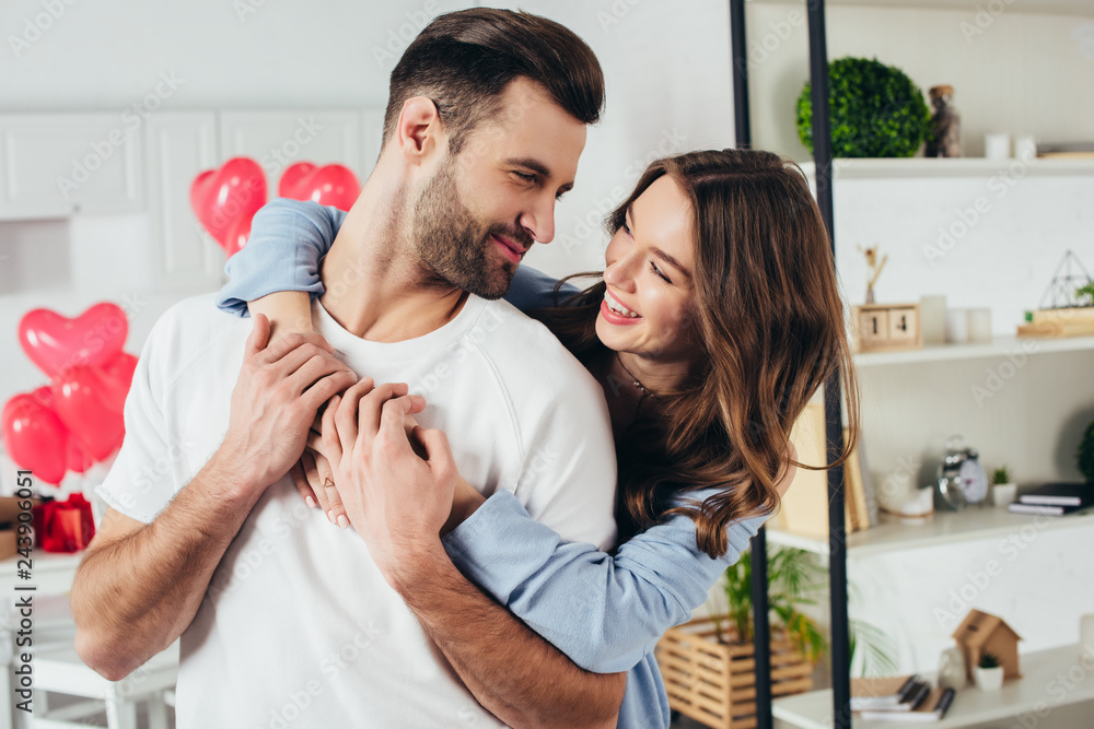 selective focus of happy girl embracing boyfriend at st valentines day selective focus of happy girl embracing boyfriend at st valentines day
