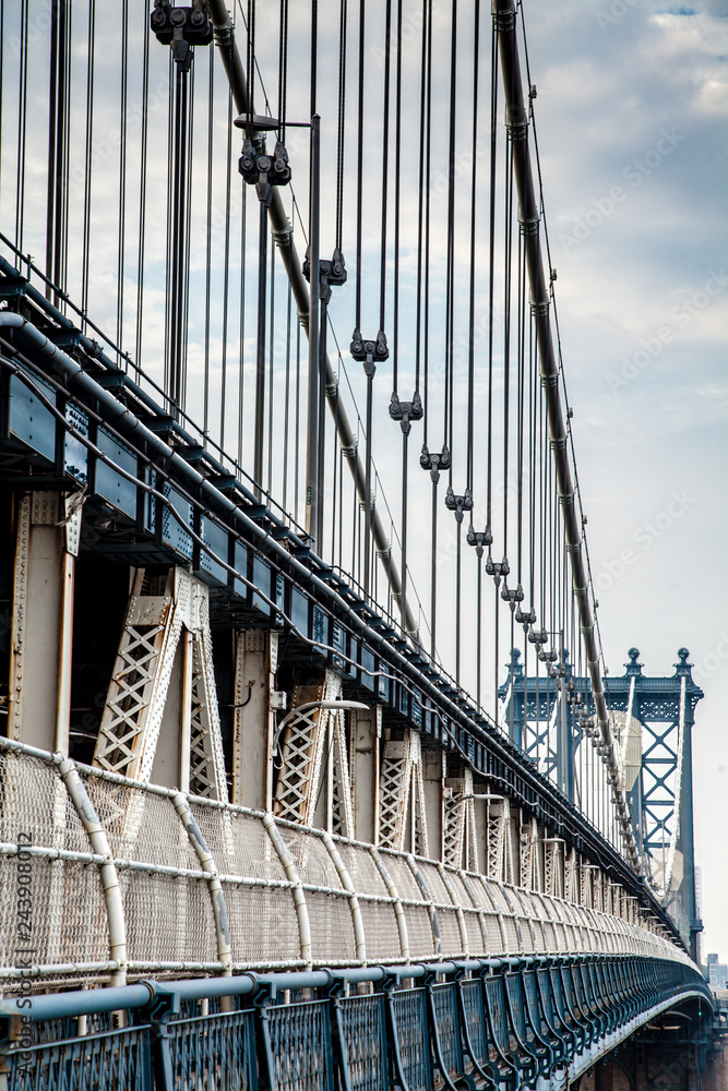 Fototapeta premium Manhattan Bridge closeup in the morning with colorful cloud over East River in Lower Manhattan in New York City