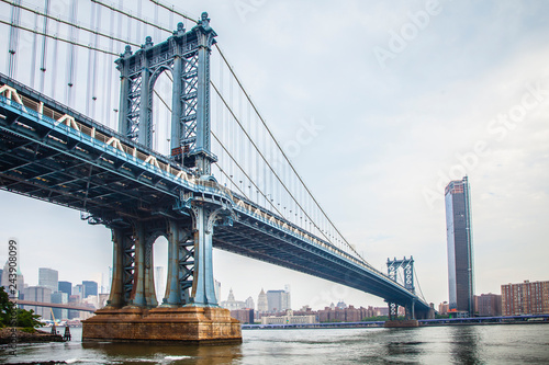 Manhattan Bridge closeup in the morning with colorful cloud over East River in Lower Manhattan in New York City