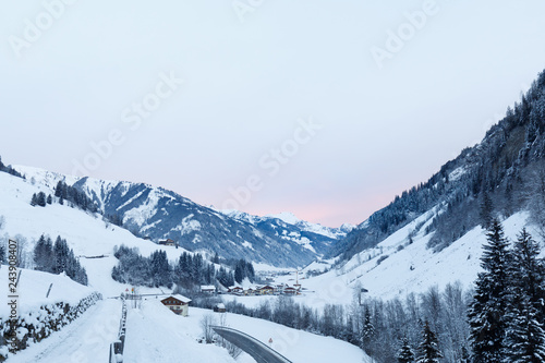 orange sunrise in valley großarl, austria in winter with snow