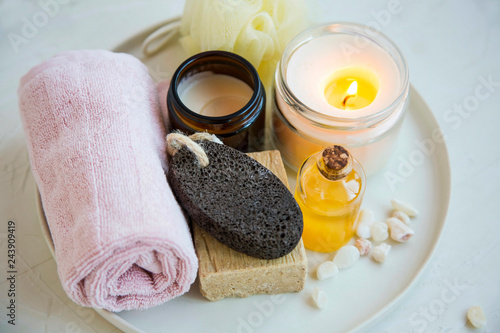 pa and beauty treatment products  with scented candle, oil, soap, cream and towel, wellness and spa products