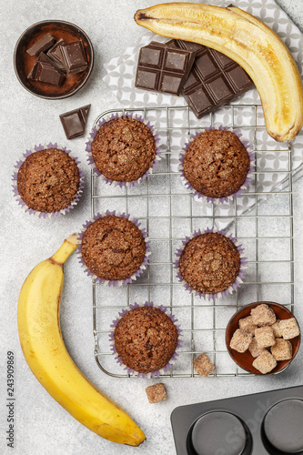 Chocolate muffins with banana and sugar crust on the cooking grill. Fresh homemade pastry. Selective focus, top view © la_vanda