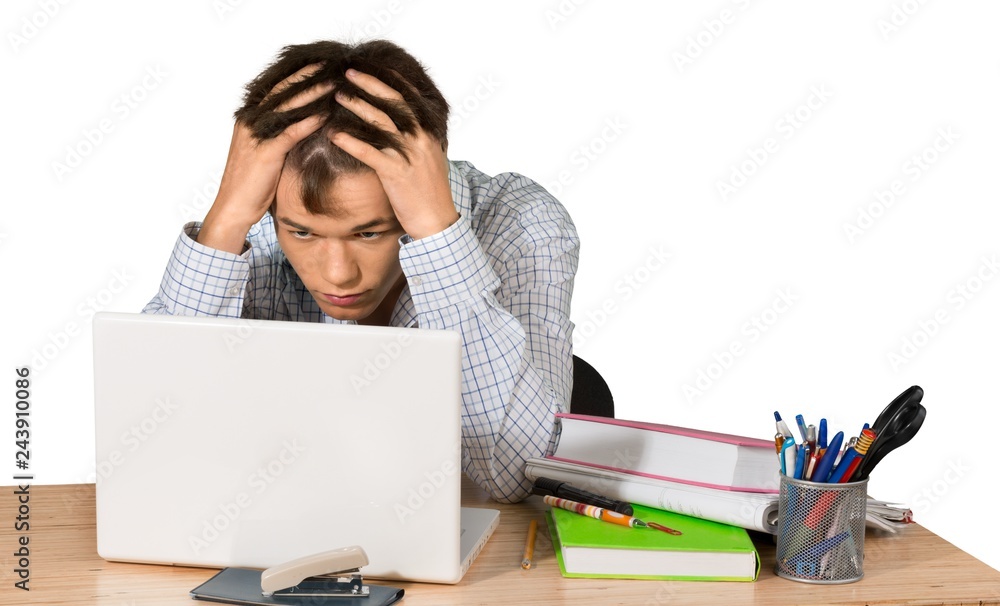 Teen male student frustrated doing school work Teen male student frustrated doing school work