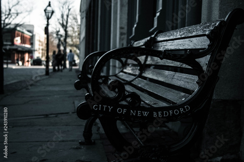 Bench on a city street photo