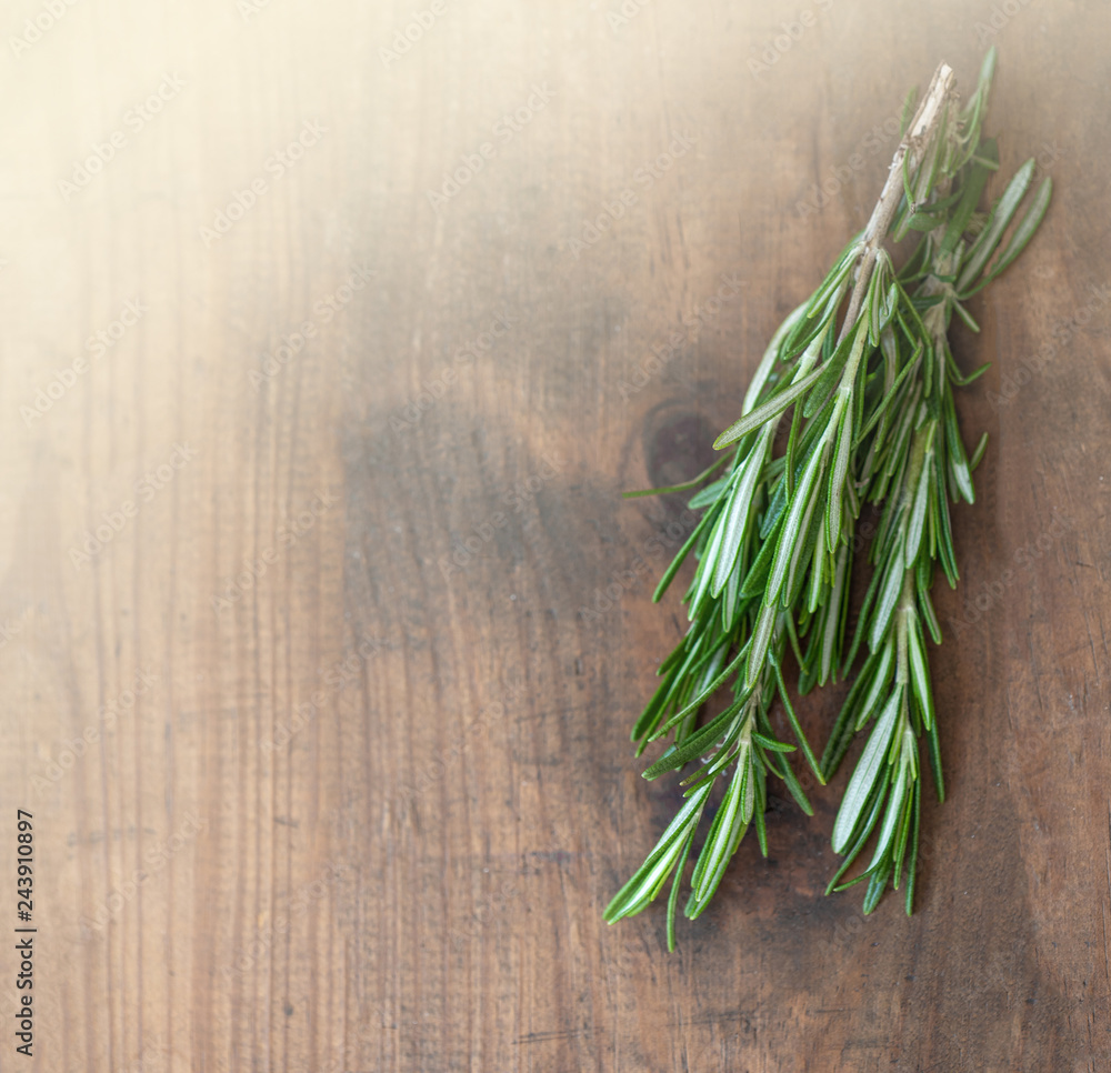 Rosemary herb bound on a wooden background with copy space. Fresh rosemary. Top view. Rosemary herb bound on a wooden background with copy space. Fresh rosemary. Top view.