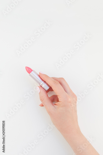 Woman hand with pink lipstick