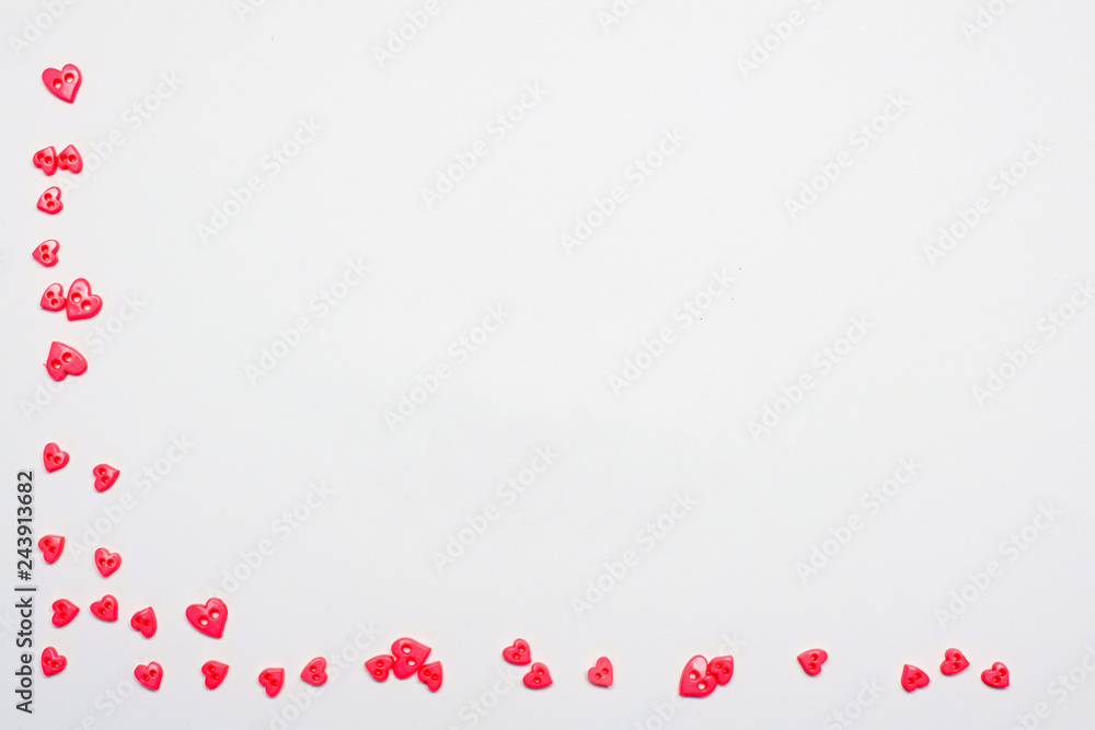 Small pink hearts on the bottom and left edge on a white background