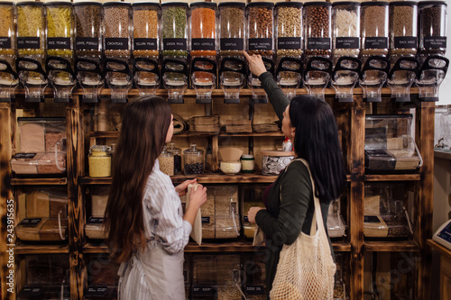Young woman buying healthy food in package free store.