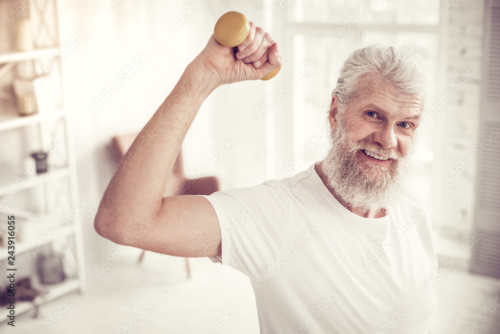 Obraz premium Pleased senior male person looking straight at camera