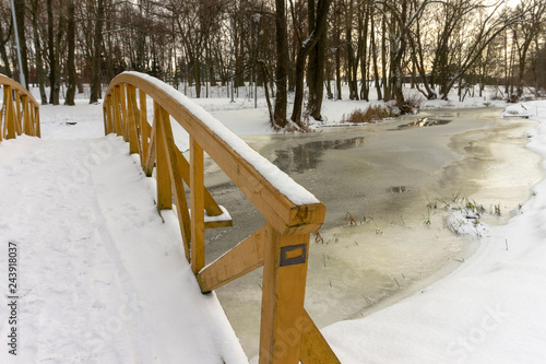Wallpaper Mural Unmoving frozen river underneath wooden bridge Torontodigital.ca