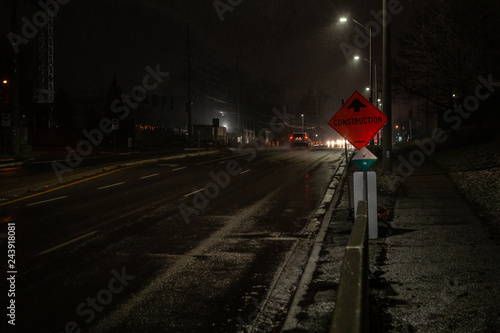 Toronto, CANADA - December 4th, 2019: Dramatic rainy night with empty streets and reflecting traffic lights in city suburbia roads