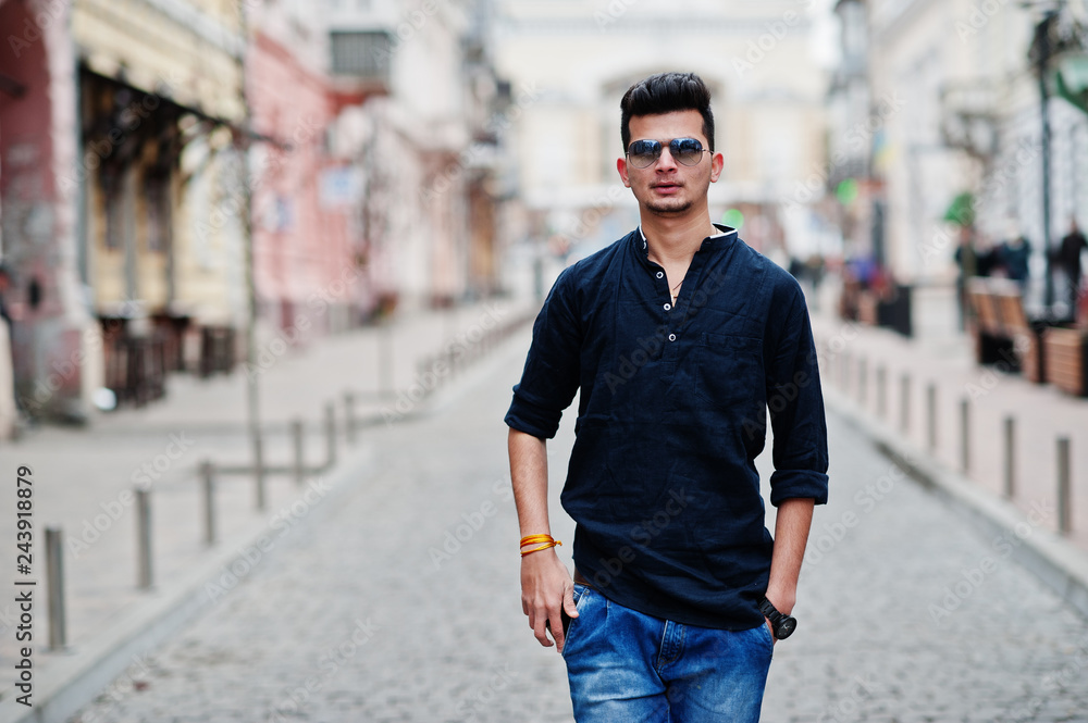 Stylish indian model man in casual clothes, black shirt and sunglasses  posed outdoor at street of India. Stock Photo | Adobe Stock