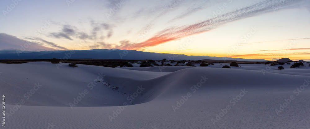 Beautiful panoramic view of white sand during a colorful sunrise. Taken in White Sands National Monument, New Mexico, United States.