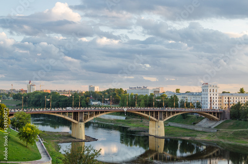 Vitebsk. The bridge over the Vitba River, which flows into the Western Dvina. Republic of Belarus. Beautiful view of the city. City landscape. Sunset, textured sky, a lot of clouds, small river in sum