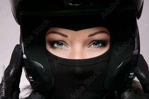 Beautiful woman in black biker's helmet
