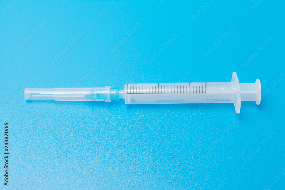 medical abstract: syringe on a blue background with injection medical abstract: syringe on a blue background with injection