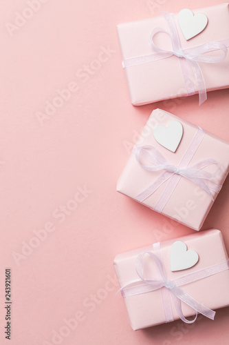 Fototapeta Naklejka Na Ścianę i Meble -  Pink valentine gift frame layout with white hearts on a pastel pink background