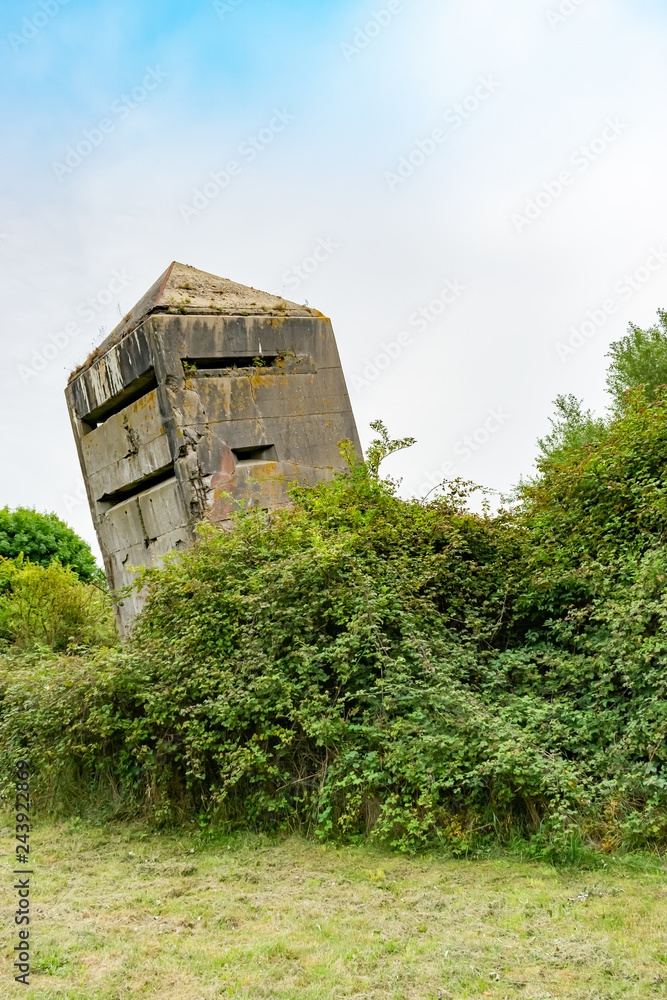 Tilted original old German bunker from World War II La Tour Penchee (the leaning tower) in Oye Plage, Nord-Pas-de-Calais, France.