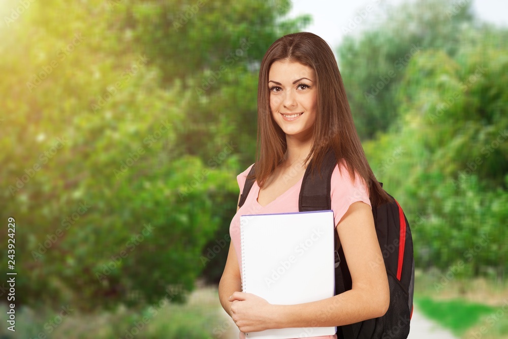 Beautiful young woman with clipboard looking at camera Beautiful young woman with clipboard looking at camera