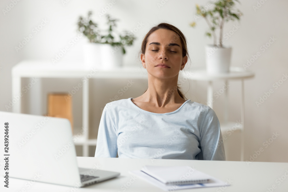 Calm attractive woman relaxing at workplace, sitting with closed eyes, leaning back in chair, meditating at work, deep breath, no stress concept, businesswoman, student resting after finish work Calm attractive woman relaxing at workplace, sitting with closed eyes, leaning back in chair, meditating at work, deep breath, no stress concept, businesswoman, student resting after finish work