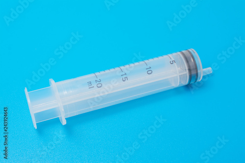 big syringe isolated on a blue background