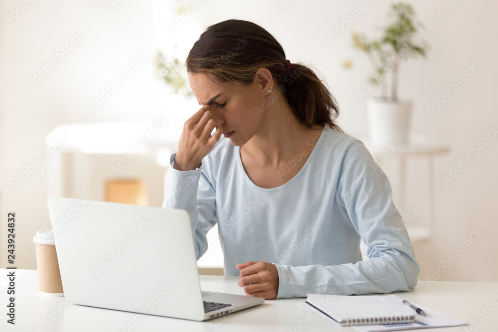 Upset woman feeling tired after long hours computer work, sitting at workplace, massaging nose bridge, bad vision concept, businesswoman, student suffering from eye strain, fatigue after laptop use Upset woman feeling tired after long hours computer work, sitting at workplace, massaging nose bridge, bad vision concept, businesswoman, student suffering from eye strain, fatigue after laptop use