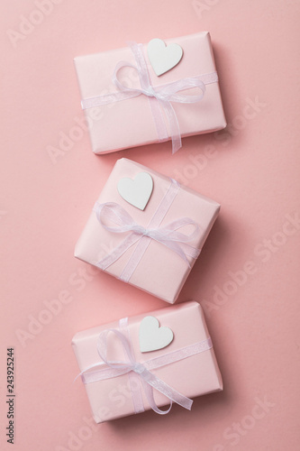 Pink valentine gift with white hearts on a pastel pink background © ink drop