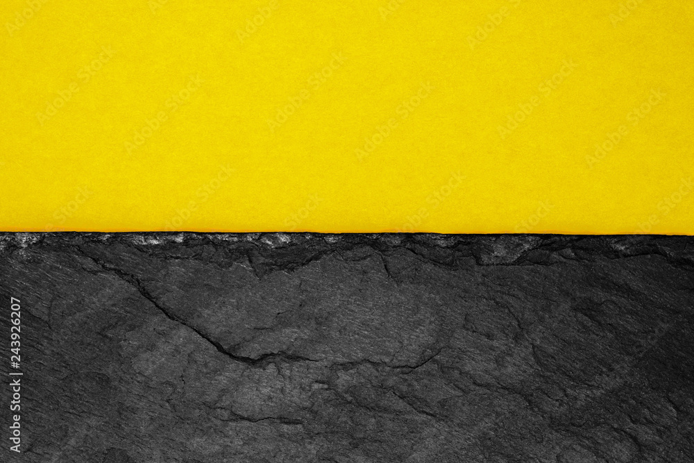 Abstract background composition of divided in the half matt dark yellow color paper and black