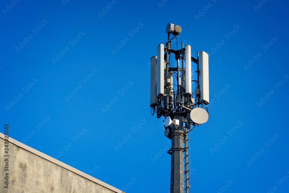 Close up of telecommunications tower mast against blue sky Close up of telecommunications tower mast against blue sky