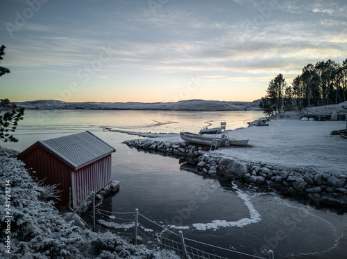 Sunset on the fjord, frosted vegetation, ice on the water, Norway © mariuszks