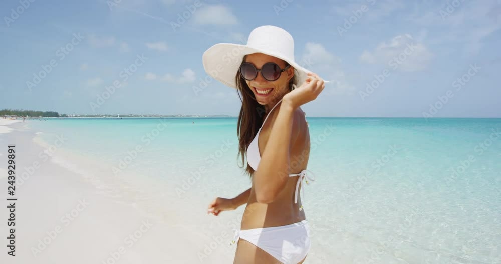 Bikini beach woman happy smiling laughing energetic. Bikini girl wearing sunglasses looking at camera excited and joyful. Beautiful sexy mixed race woman having fun on summer travel vacation. Bikini beach woman happy smiling laughing energetic. Bikini girl wearing sunglasses looking at camera excited and joyful. Beautiful sexy mixed race woman having fun on summer travel vacation.