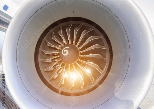 Close up of fan jet engine turbine with sunlight.