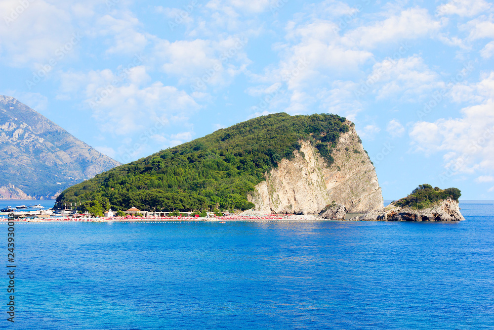 St. Nicholas island near Budva in Montenegro. Coast with blue sea, rocks and sky with clouds