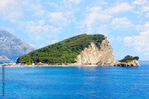 St. Nicholas island near Budva in Montenegro. Coast with blue sea, rocks and sky with clouds