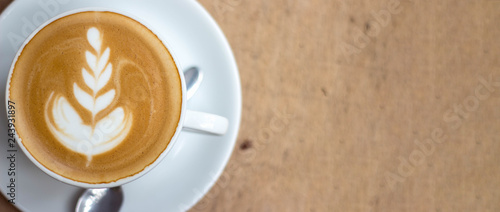 I like to place a cup of coffee at my favorite table. Coffee cup top view on wooden. Soft focus, Noise, Top view