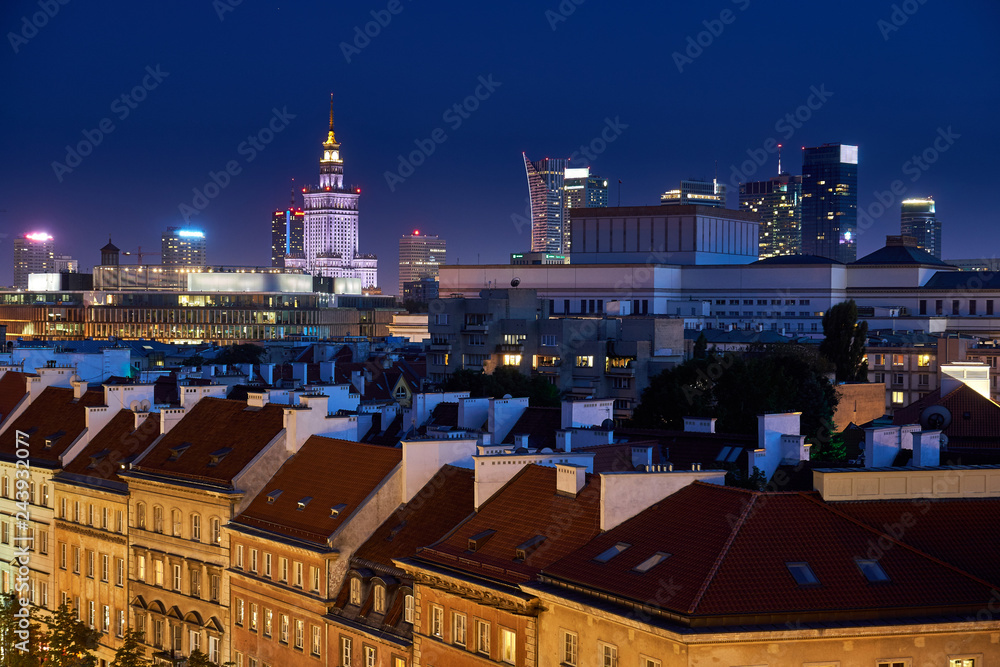 Warsaw, Poland - August 11, 2017: Beautiful panoramic night view over the roofs of the Old Town to the Center of Warsaw, the Palace of culture and science (PKiN), modern skyscrapers and Krakowskie Prz