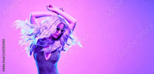 High Fashion. Gorgeous Disco Party girl with glowing purple dyed hair dance. Young beautiful model woman in Colorful neon Light. Night Clubbing. Stylish fashionable banner