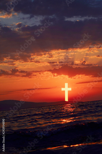Crossing in the form of the sun in sunset with the orange sky in the evening can be used as a background. Worship and praise God concept