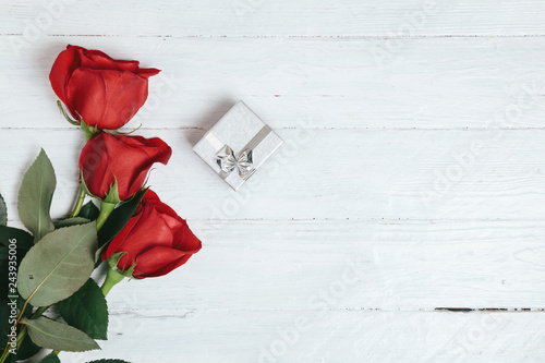 bouquet of red roses on a white background, silver box