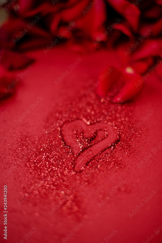 Red drowing heart on red background with red roses petals Red drowing heart on red background with red roses petals