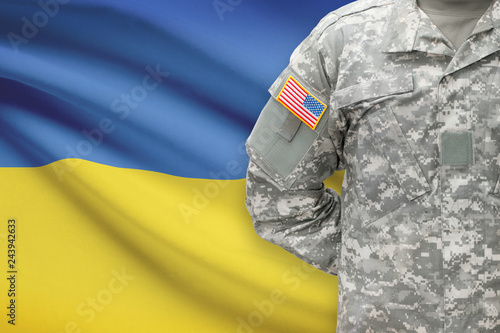 American soldier with flag on background - Ukraine